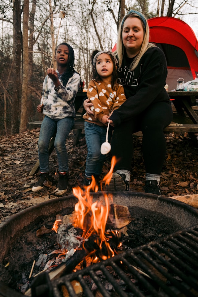 Family roasting marshmallow at camp